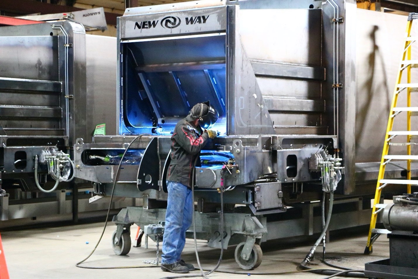 Welder working in New Way Trucks manufacturing facility